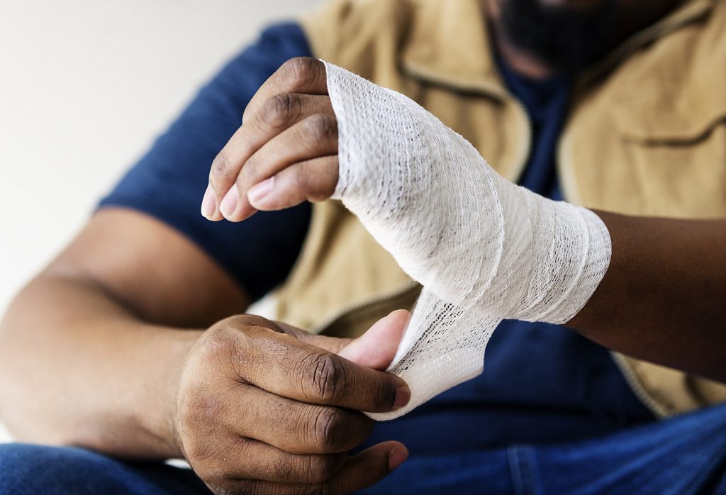 Man Wrapping Injured Hand After Construction Injury